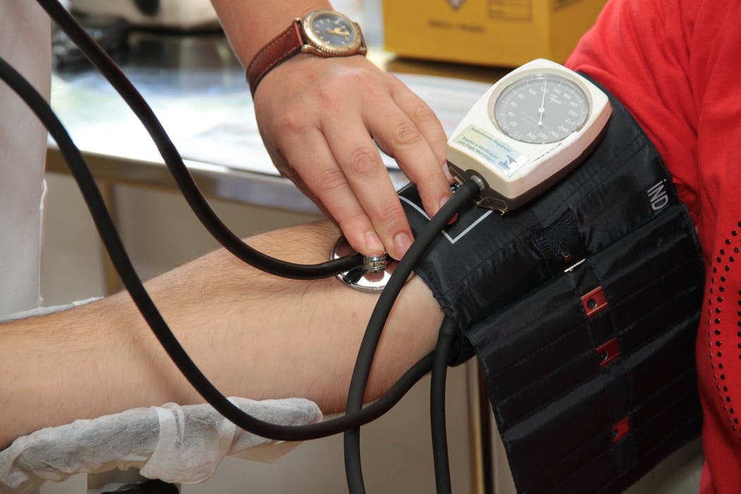 doctor checking a patient's blood pressure